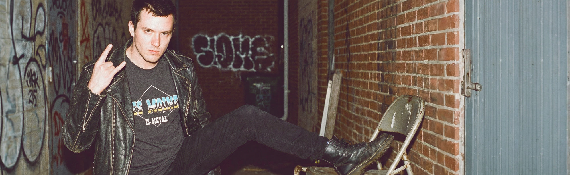 guy rocking out with an Iowa HomeTown Riot shirt