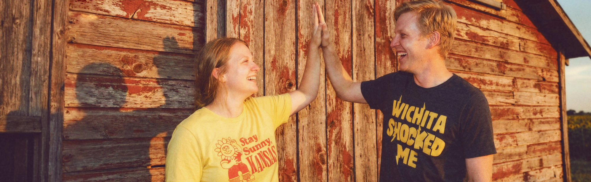 Two people wearing Kansas HomeTown Riot apparel